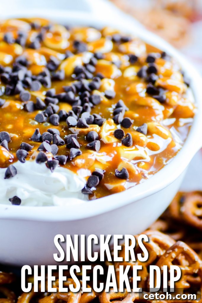Decadent Snickers Dip 2 This Snickers Dip is the perfect Super Bowl food! A creamy no-bake cheesecake base is topped with rich caramel, salty peanuts, and chocolate chips. Serve with pretzels, apples, and graham crackers for dipping.