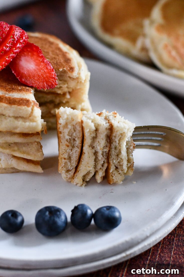 Delicious stack of fluffy eggless pancakes with fruit.
