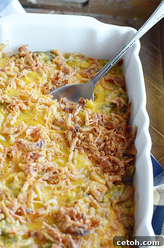 A close-up shot of a creamy, golden-brown green bean casserole, topped with perfectly crispy fried onions, ready to be served at an Easter dinner.