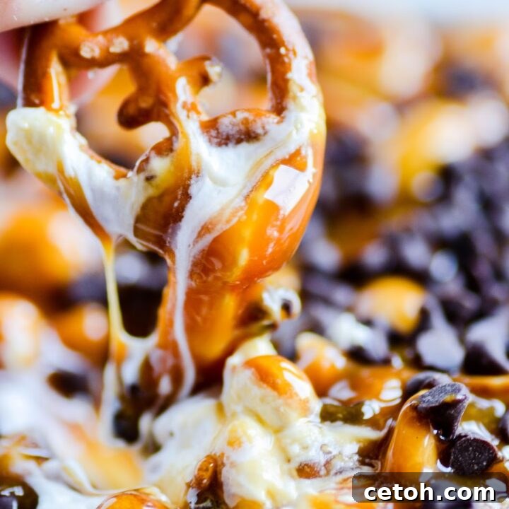Touchdown Desserts: 15 Effortless Super Bowl Sweets 4 A creamy Snickers cheesecake dip topped with caramel sauce, chopped Snickers candy, and peanuts, served with pretzels and fruit for dipping.