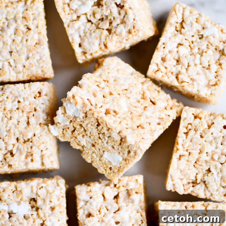 Touchdown Desserts: 15 Effortless Super Bowl Sweets 8 Gooey and soft Rice Krispies Treats, featuring delightful pockets of unmelted marshmallows for extra texture and sweetness.