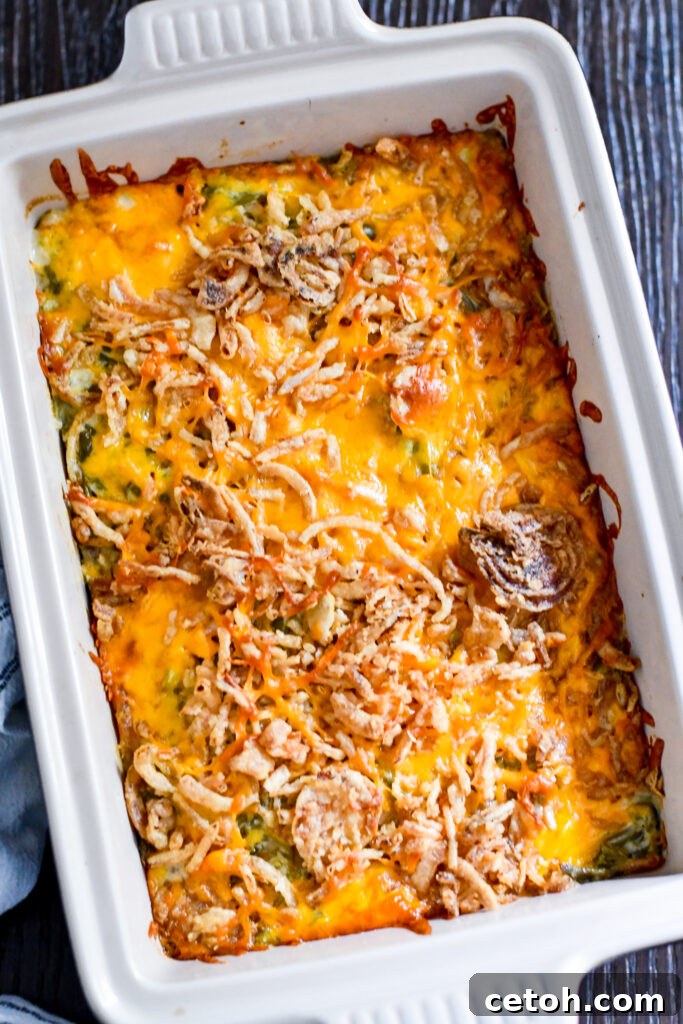Homemade green bean casserole with sour cream, cheddar cheese, and crispy onions—made for your Thanksgiving or Christmas feast!