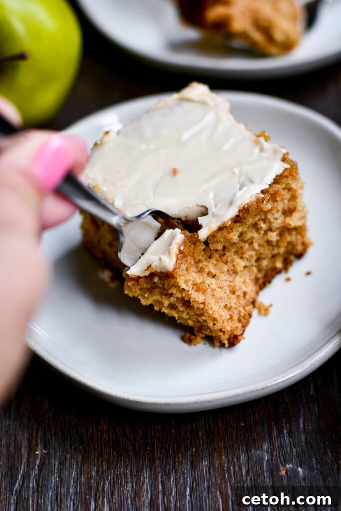 Warm applesauce cake with maple icing, perfect for autumn desserts and holidays.
