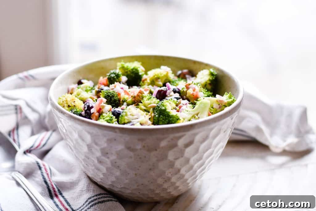 Vibrant broccoli florets, sweet red grapes, and crisp bacon ready for a delicious salad