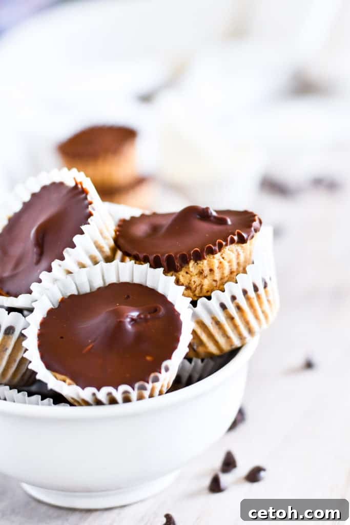 High-Protein Peanut Butter Cups 2 Delicious and healthy protein peanut butter cups arranged on a plate, showcasing their rich chocolate exterior and creamy peanut butter filling, perfect for a guilt-free treat.