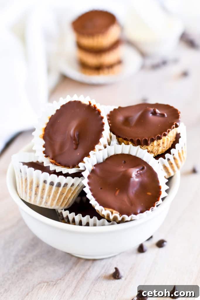 High-Protein Peanut Butter Cups 4 An overhead shot of homemade protein peanut butter cups, showing off their perfect round shape and glistening chocolate tops, ready to be picked up and savored.
