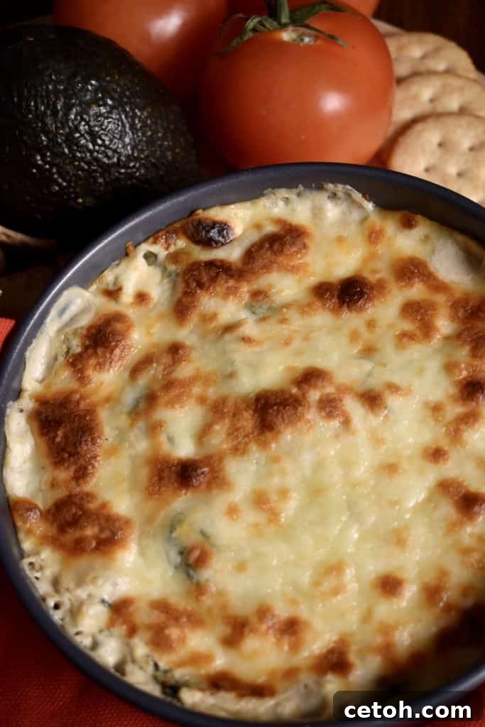 Creamy spinach artichoke dip appetizer in a baking dish