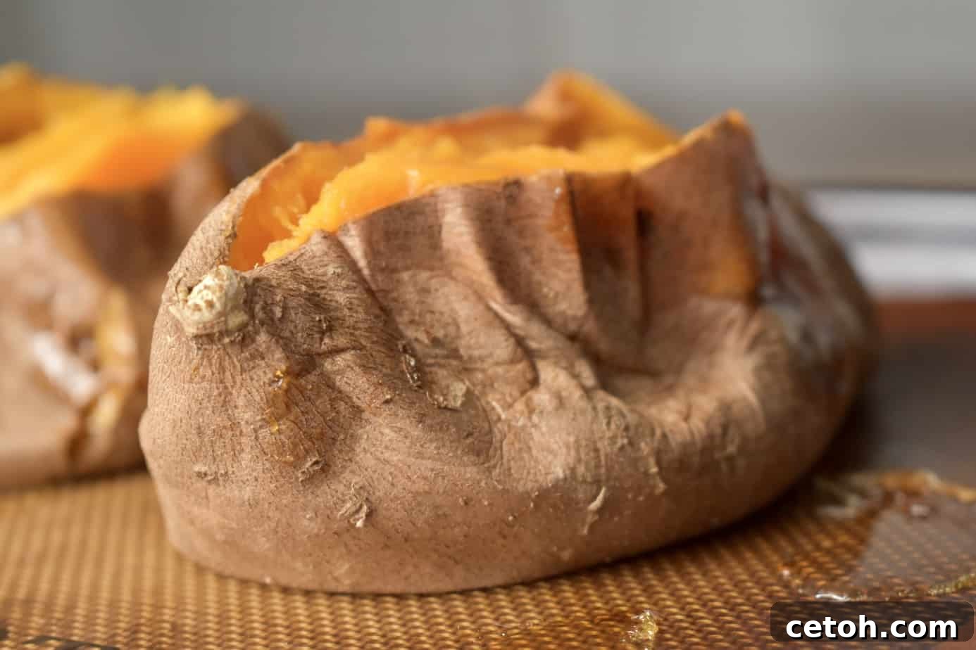 Close-up of a perfectly baked sweet potato cut open, revealing its fluffy interior