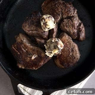 Top down photo of tenderloin steaks in a cast iron skillet