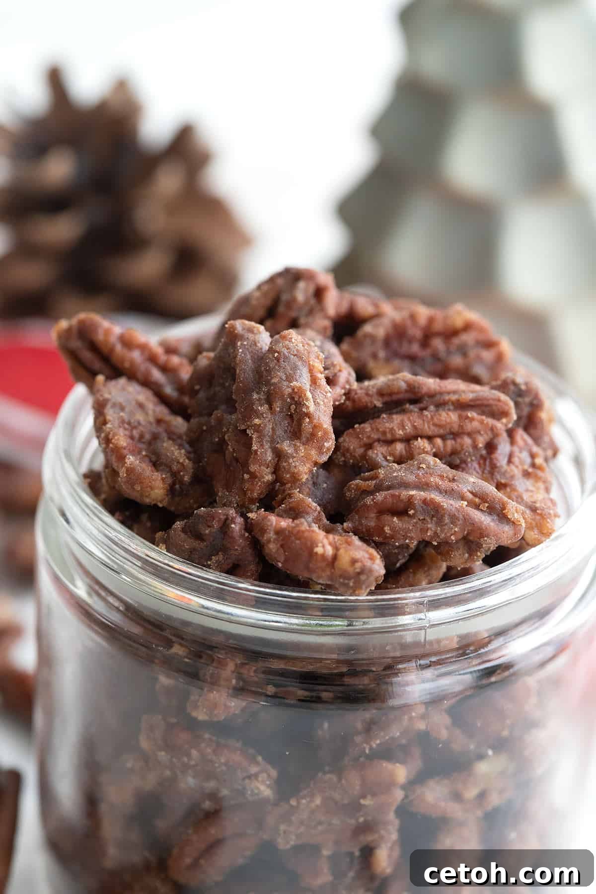 Keto Countdown Nibbles for New Year's Eve 23 Close up shot of keto candied pecans in a glass jar.