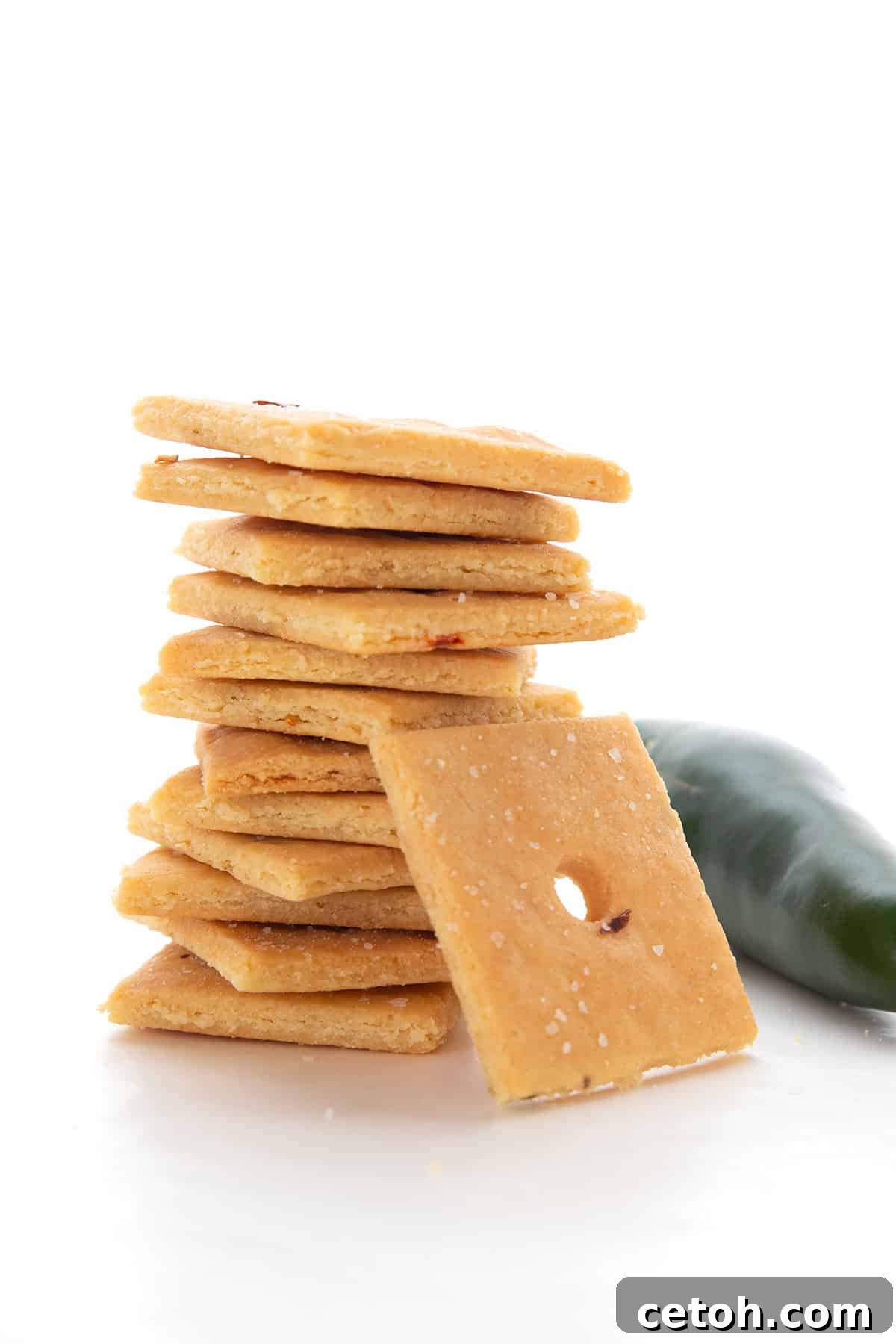 Keto Countdown Nibbles for New Year's Eve 6 A stack of Keto Cheese Crackers on a white background with a jalapeno.
