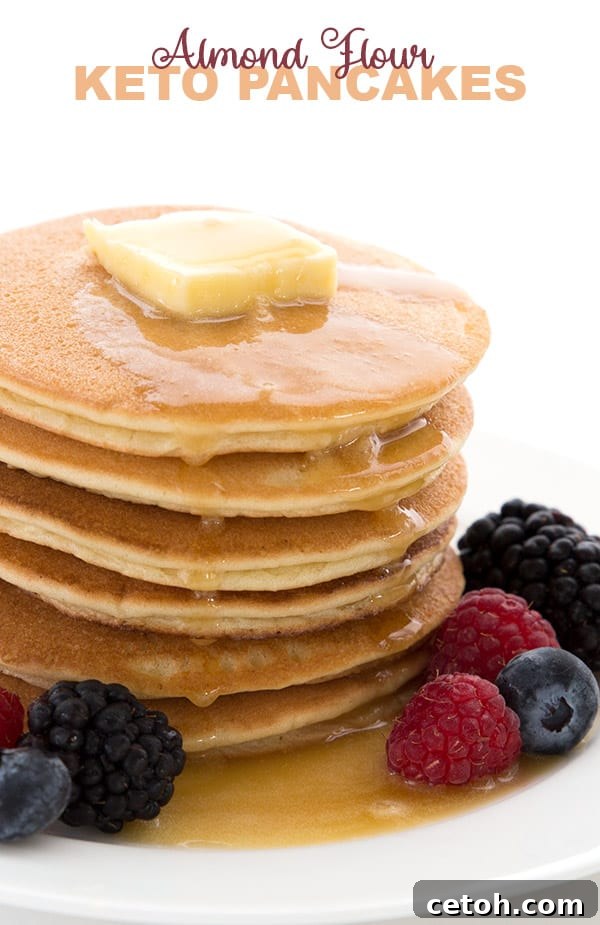 Keto Almond Flour Pancakes in a stack with fresh berries and sugar-free syrup, perfect for a low-carb breakfast.