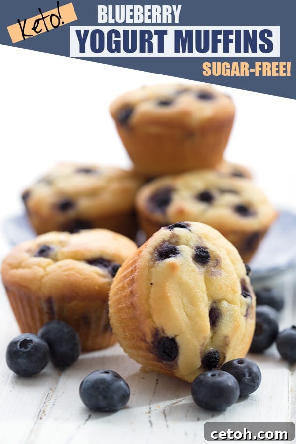 Keto blueberry yogurt muffins in a cluster with fresh blueberries, ready to be enjoyed.