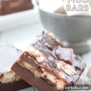Close up shot of keto Mississippi Mud Bars with a bowl of marshmallows in the background.