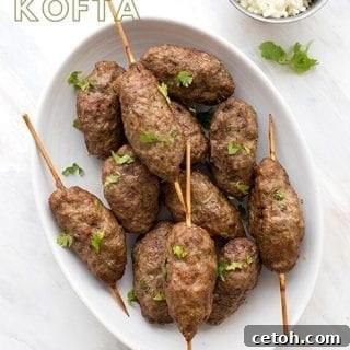 Titled image of Keto Lamb Kofta in a white oval dish with feta and cilantro