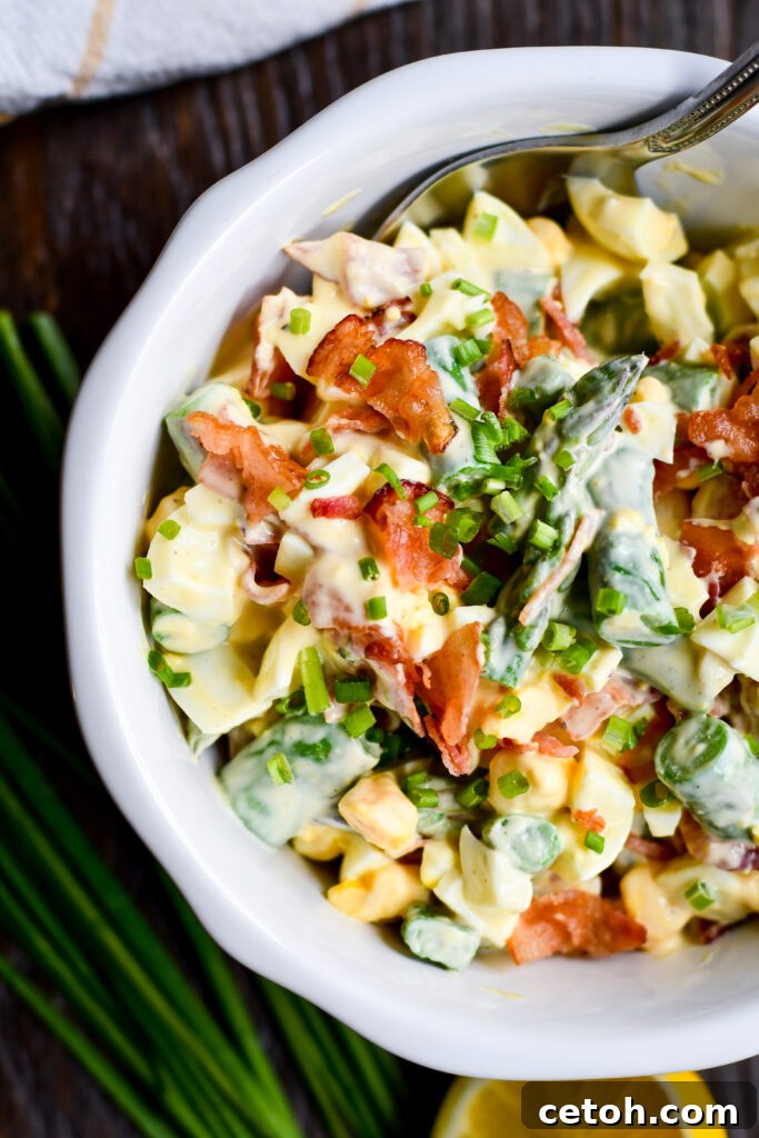 A bright, springy twist on classic egg salad—with fresh asparagus, crispy bacon, and a creamy Dijon lemon dressing.