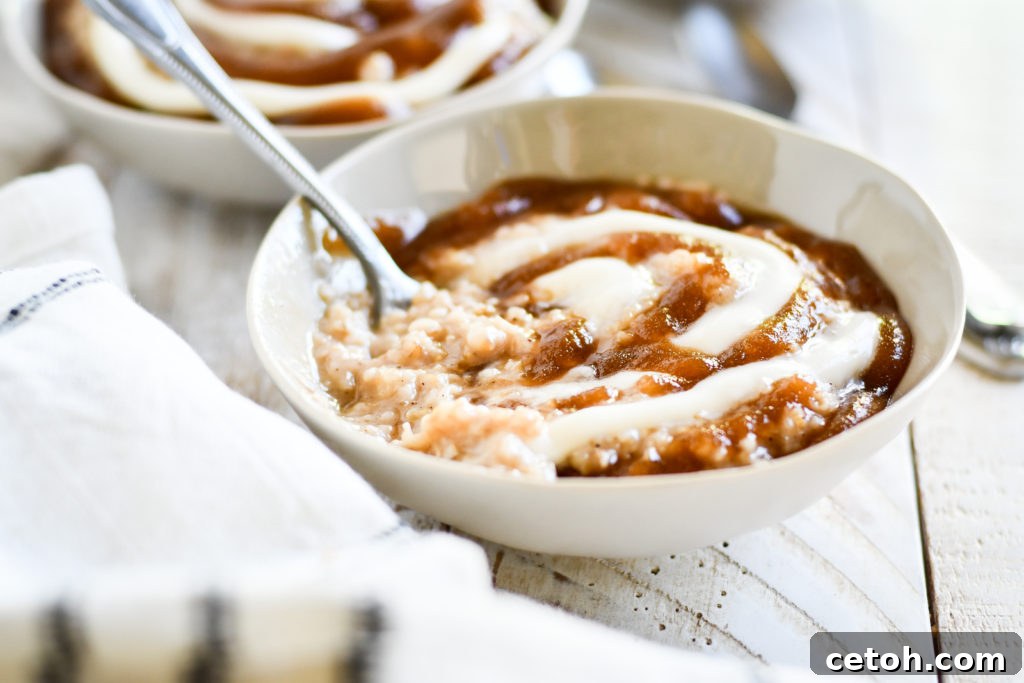 Four bowls of freshly prepared Cinnamon Roll Oatmeal, ready to be enjoyed as a delightful and comforting breakfast for the whole family.