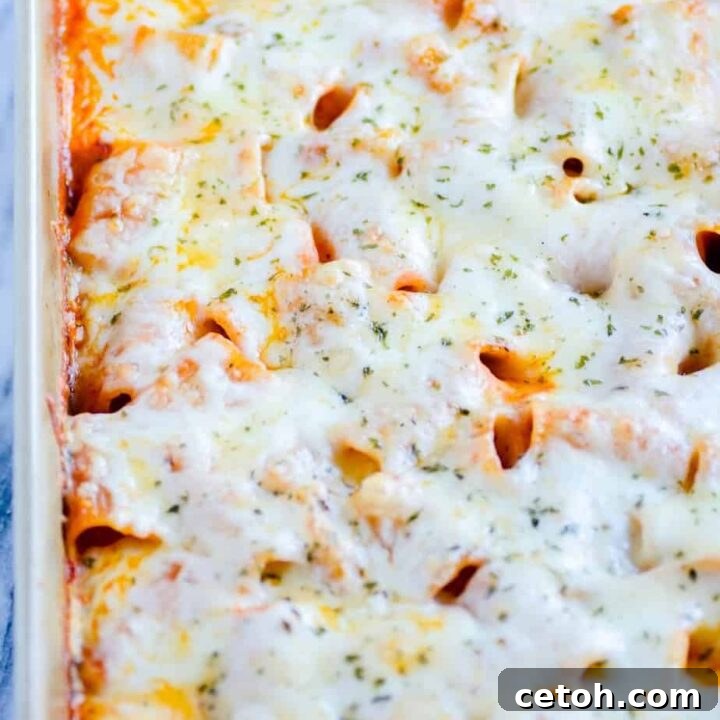 A bubbling Easy Weeknight Baked Ziti, fresh from the oven with melted cheese.