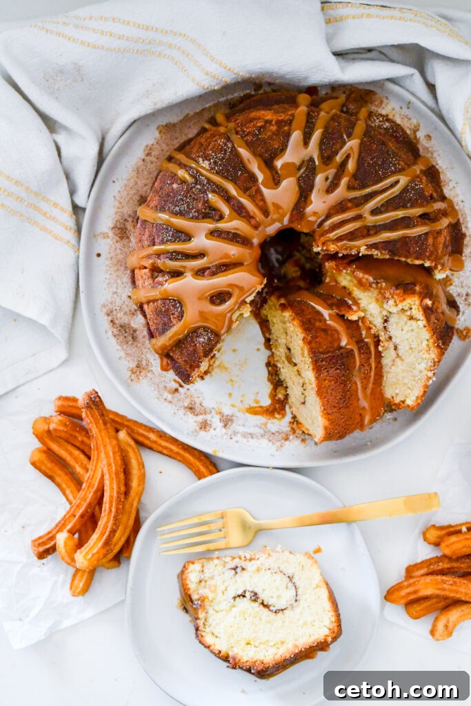 Cinnamon Sugar Delight Cake 2 Golden Churro Bundt Cake with a rich caramel drizzle, freshly baked and dusted with cinnamon sugar, perfect for dessert.