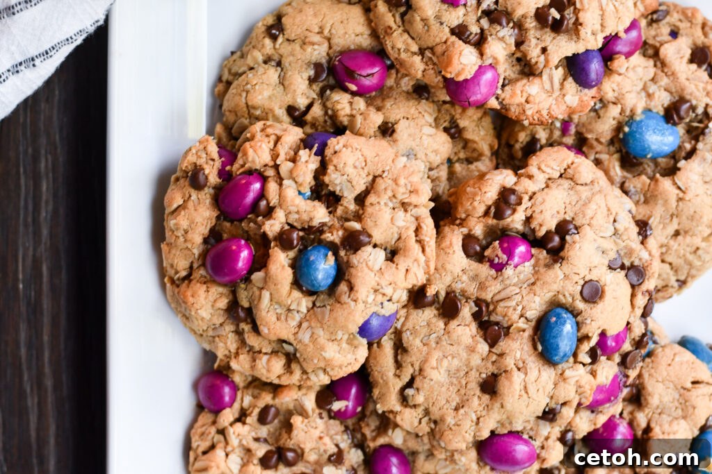 An overhead view of a cooling rack filled with golden-brown gluten-free dairy-free monster cookies, ready to be enjoyed.