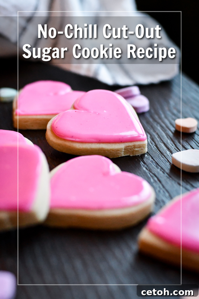 A plate of soft cut-out sugar cookies, perfectly frosted and decorated, showing they hold their shape without chilling time.
