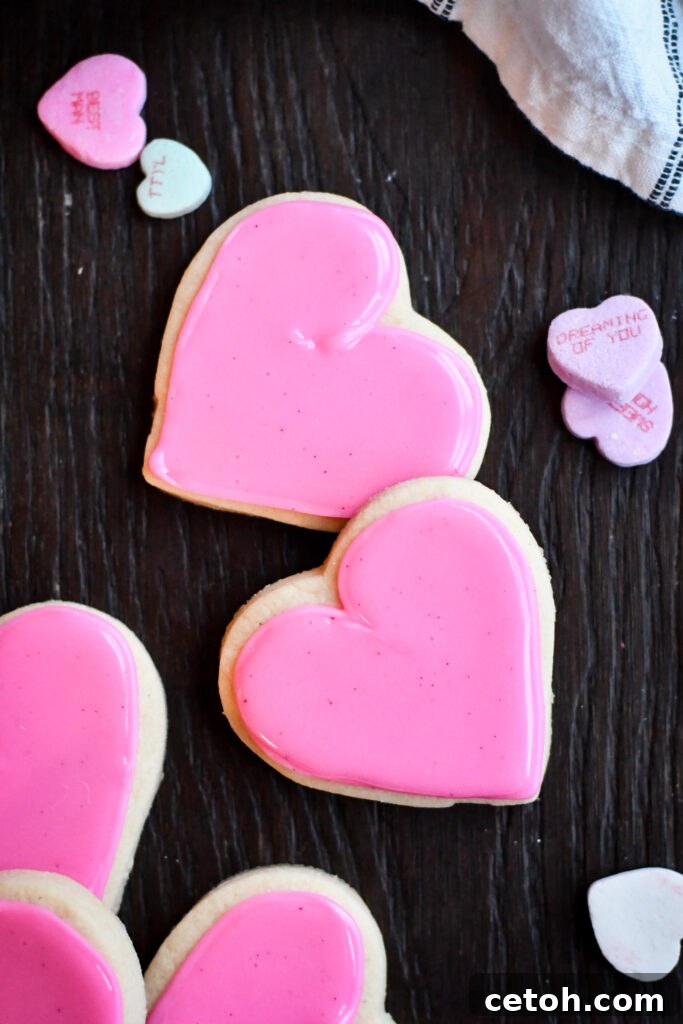 A close-up of beautifully decorated, soft cut-out sugar cookies that effortlessly hold their shape, proving no chill time is needed.