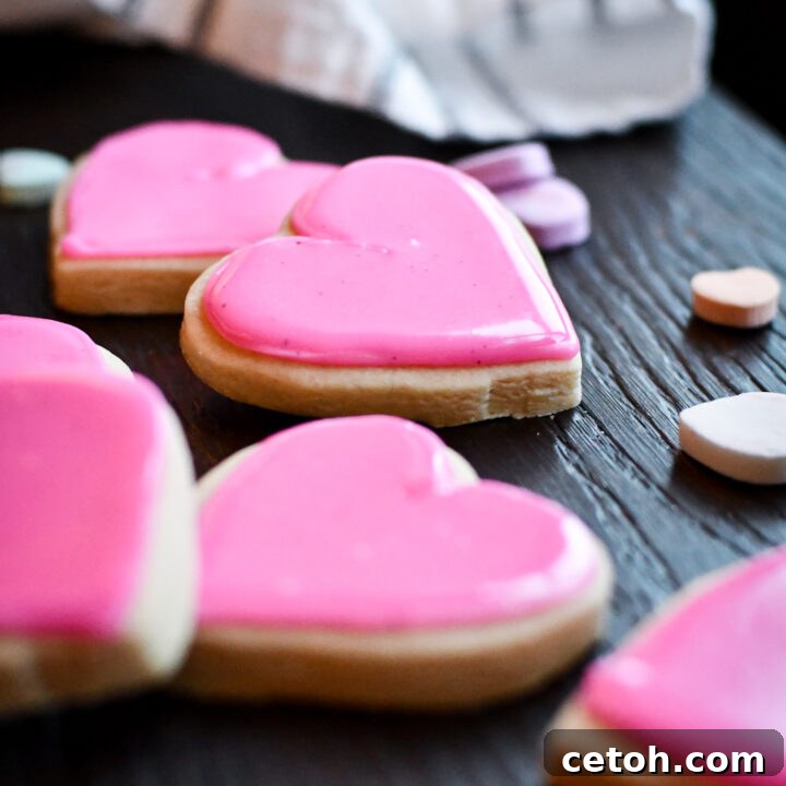 No chill time required with this easy and delicious no-chill sugar cookie recipe, showcasing a stack of beautifully frosted cookies.