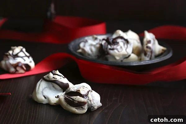 These easy chocolate swirled meringues are perfect for last minute Christmas baking! Low carb and gluten-free, with a festive swirl.
