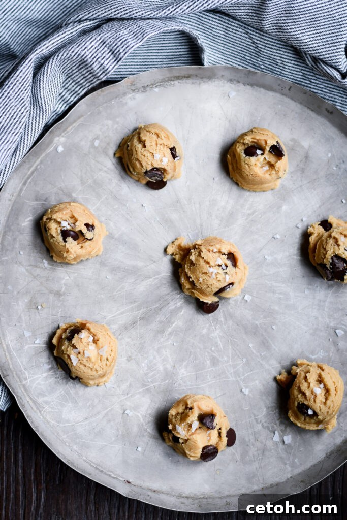 A large mixing bowl filled with rich chocolate chip cookie dough, ready for scooping.