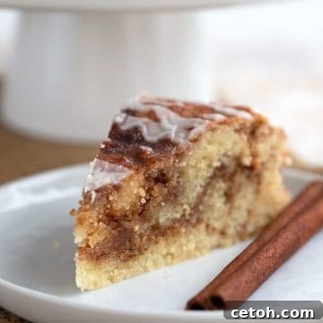 Close up shot of a slice of keto cinnamon roll bread, showing the moist texture and swirled filling.