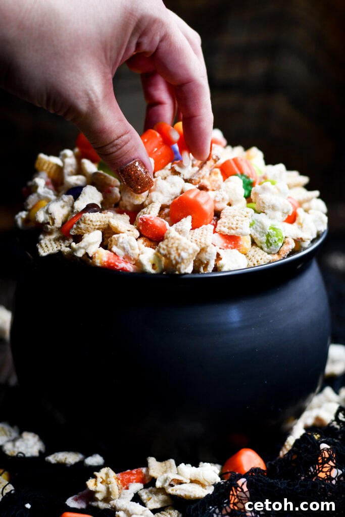 Easy Halloween Popcorn Treat with Candy Corn 6 A bewitching blend of flavors in our homemade Halloween Popcorn Snack Mix, ready for your next spooky gathering.