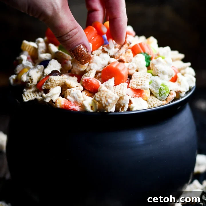 A bewitching blend of flavors in our homemade Halloween Popcorn Snack Mix with candy corn, M&Ms, and pretzels.