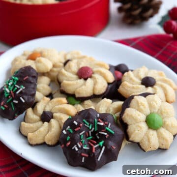 Keto Spritz Cookies on a white plate over a red patterned napkin.