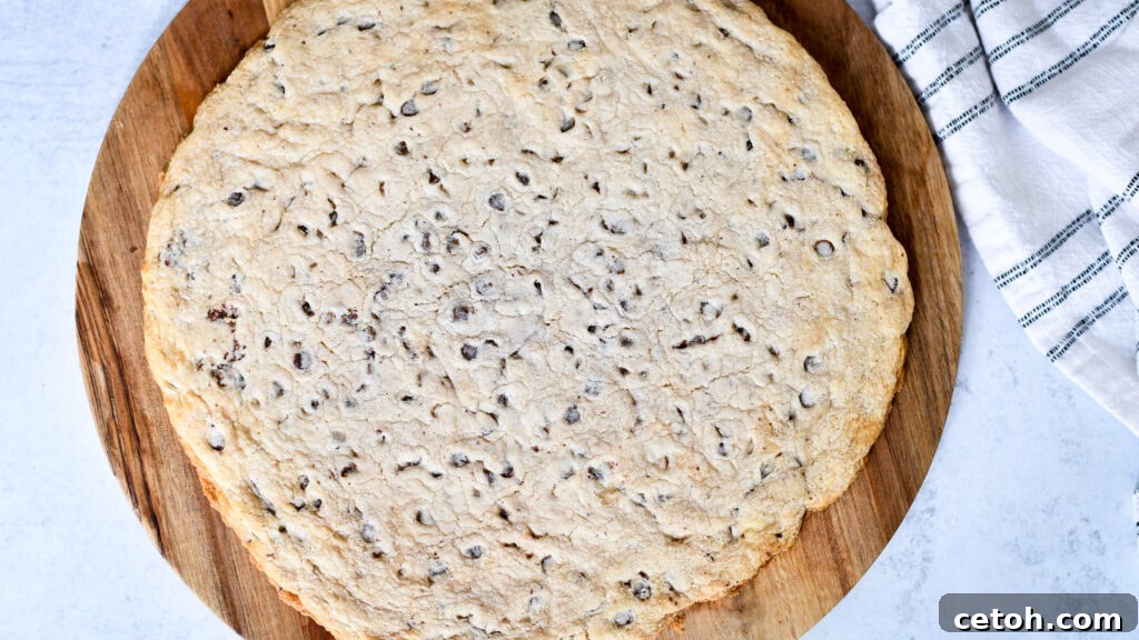 Lightly grease a 12-inch pizza pan and press the store-bought cookie dough evenly into the pan for your Smart Cookie cake.