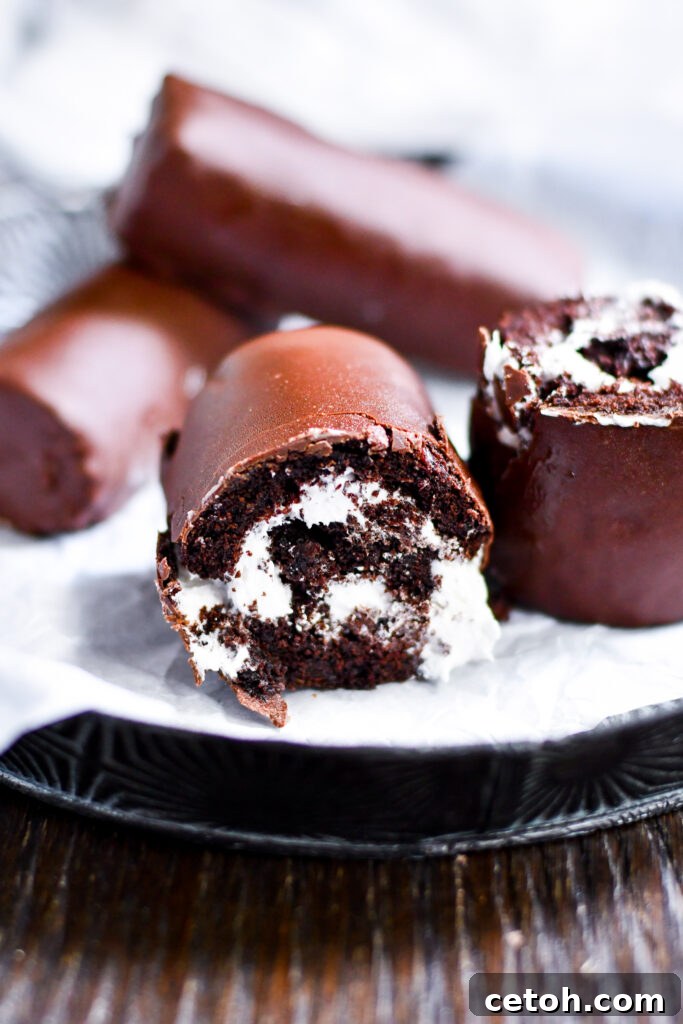 Indulge in the nostalgic delight of homemade Swiss roll snack cakes! This easy copycat recipe guides you through creating soft chocolate sponge cake, creamy filling, and a rich chocolate coating, making it the perfect treat to satisfy your sweet tooth.