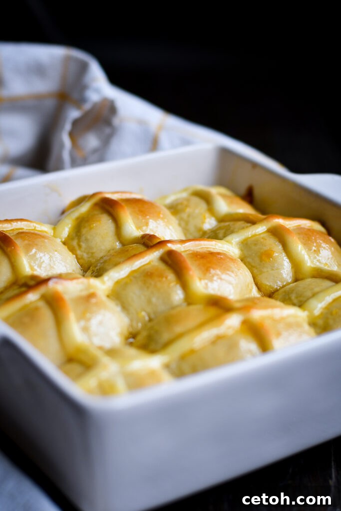 This hot cross buns recipe is perfect for those who don’t love dried fruit! Fluffy cinnamon dough, a rich cheesecake cross, and a sweet apricot glaze make them extra special for Easter or any time of year.