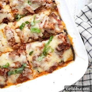 Top down image of zucchini lasagna in a white baking pan.