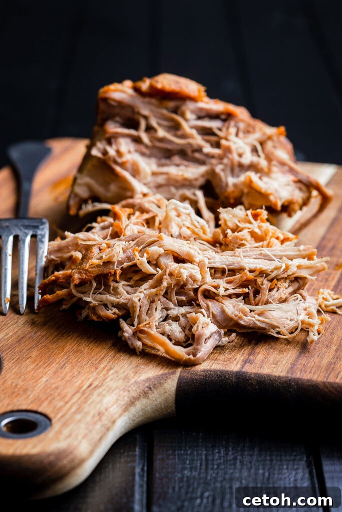 The savory aroma of Dutch Oven Boston Butt BBQ fills the kitchen, promising a delicious meal.