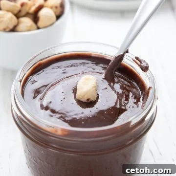 A jar of sugar free nutella with a hazelnut on top, representing a delicious keto chocolate hazelnut spread.