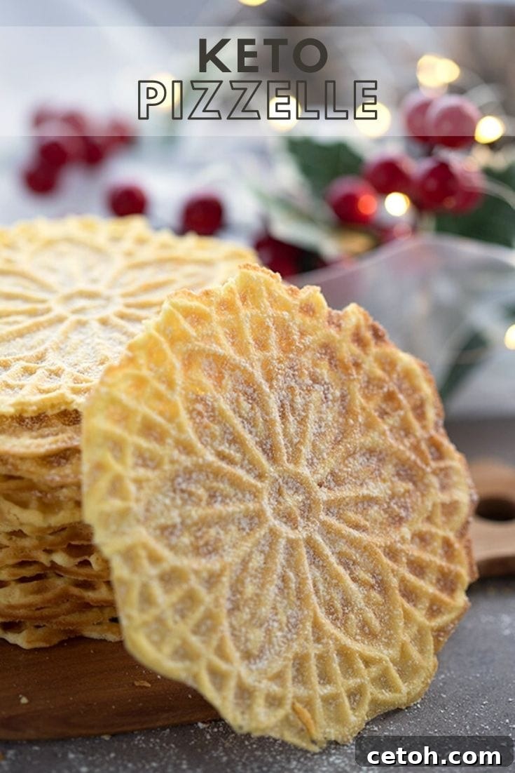 A single keto pizzelle sits elegantly in front of a stack of more beautifully patterned waffle cookies, suggesting a delicious treat.