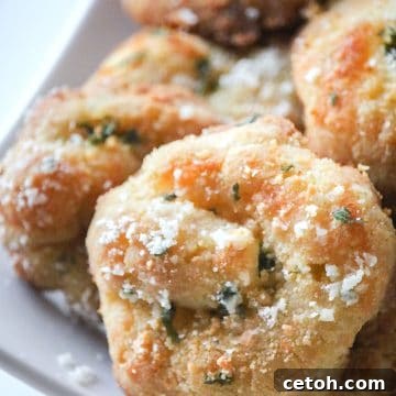 A close up shot of keto garlic knots on a white serving platter.