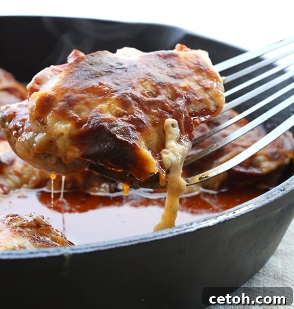 A vibrant pizza chicken dish, showcasing melted cheese and fresh herbs, baked to perfection.