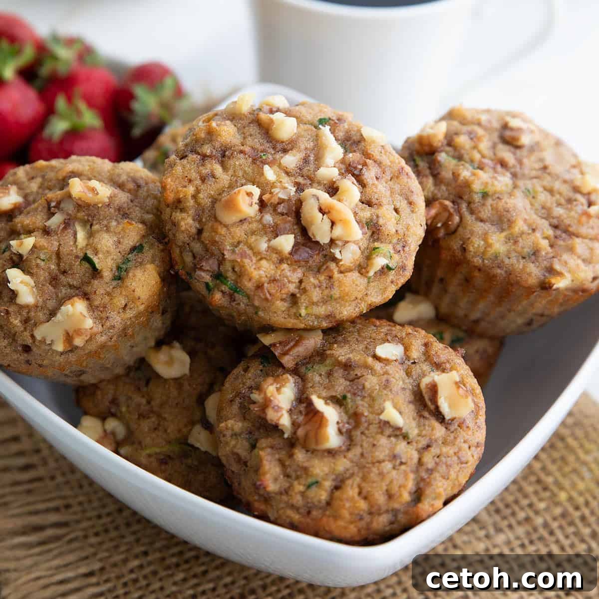 Close up shot of tender keto zucchini muffins with walnuts.