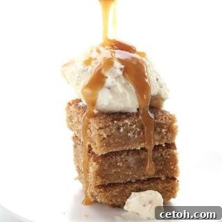 Sugar-free caramel sauce is poured over a tempting stack of Snickerdoodle Blondies, topped with a scoop of keto vanilla ice cream.