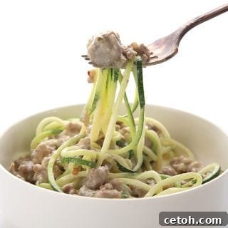 Creamy Sausage Zucchini Alfredo 2 Easy keto alfredo sauce with sausage and zucchini noodles in a bowl and on a fork.