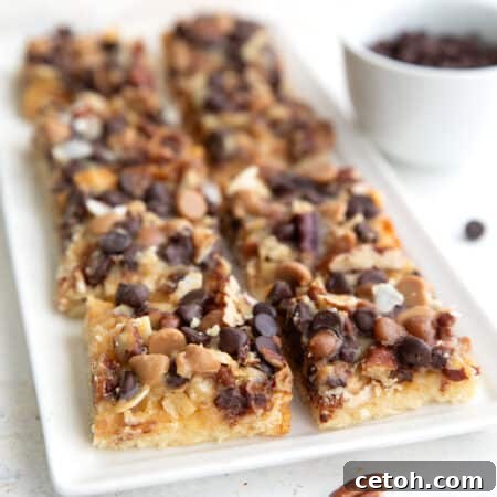 Keto Dream Bars 2 Keto Magic Cookie Bars lined up on a white rectangular tray.