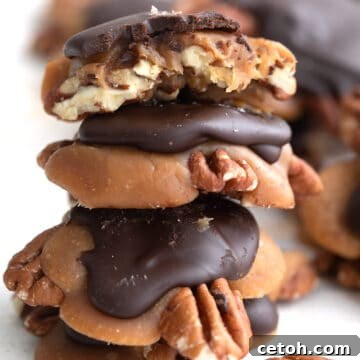 Decadent Keto Turtle Clusters 2 A stack of Keto Pecan Turtles on a white table.
