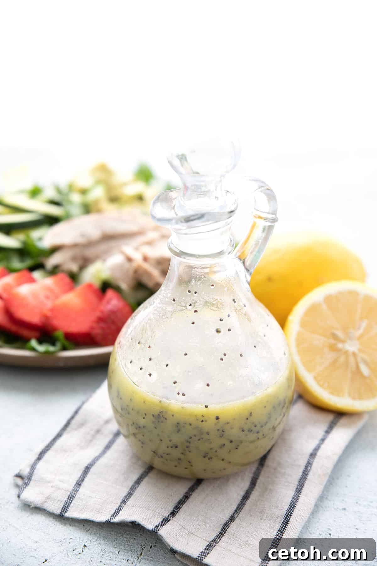 Elevate Your Keto Salads with Top Dressing Choices 7 Keto Lemon Poppy Seed Dressing on a striped napkin with lemons and salad in the background.