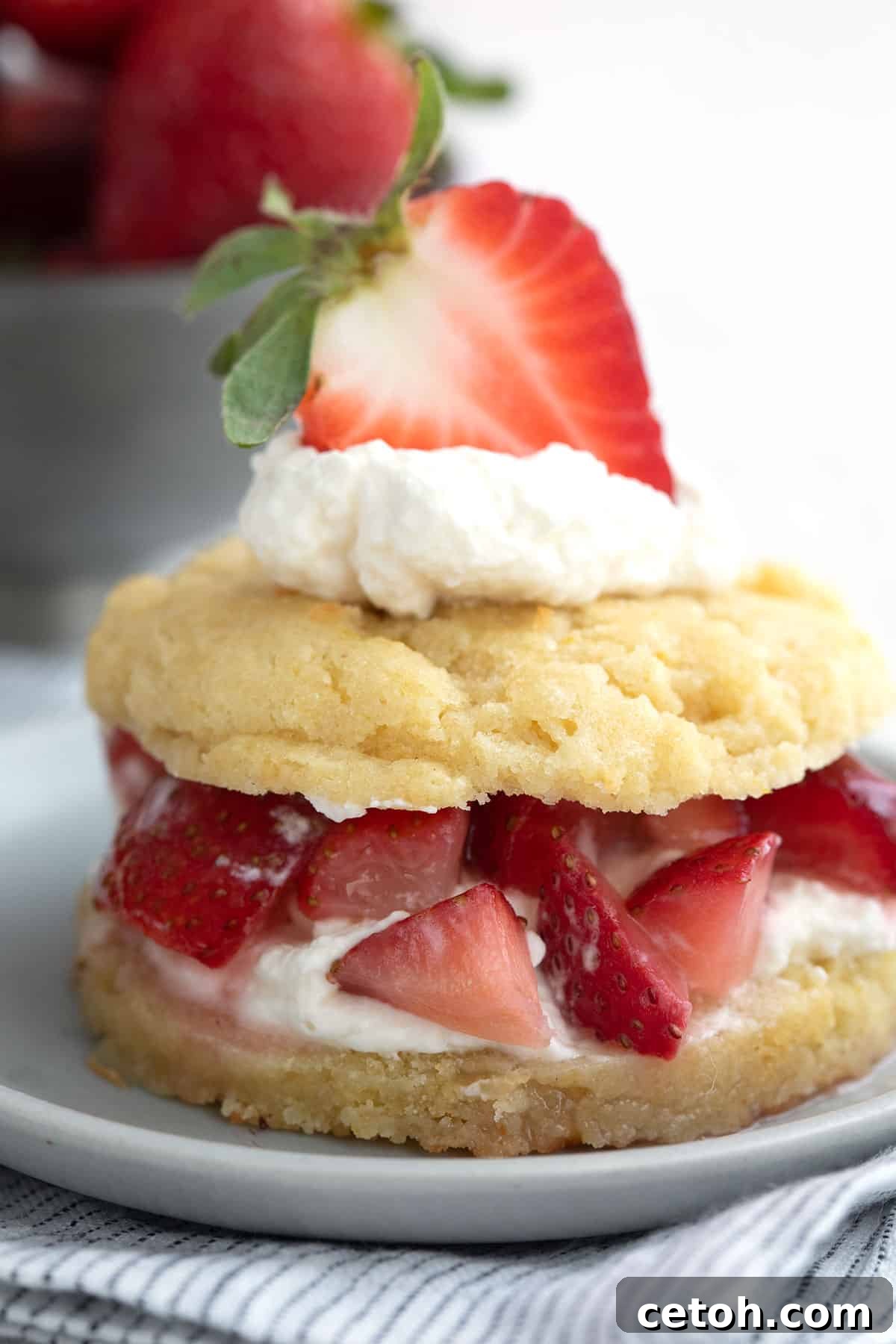 Close up shot of Keto Strawberry Shortcake on a plate over a striped napkin.