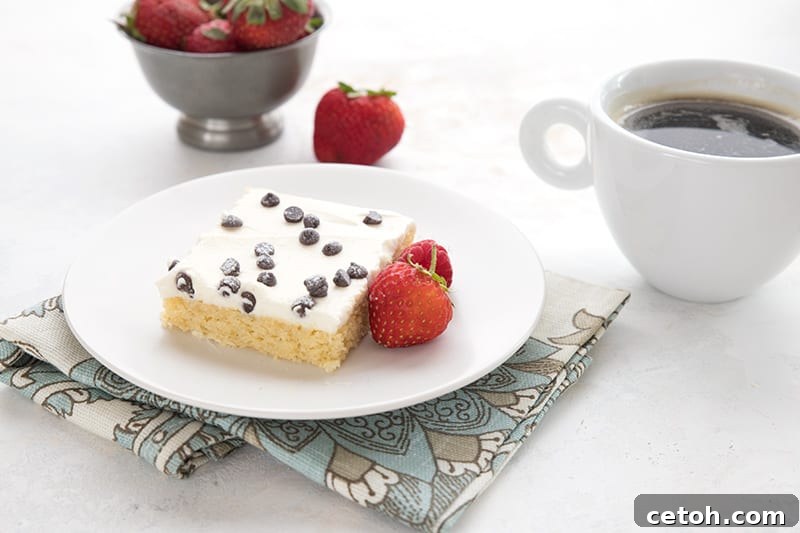 Keto Cannoli Dream Cake 4 A slice of keto cannoli cake on a plate with strawberries.